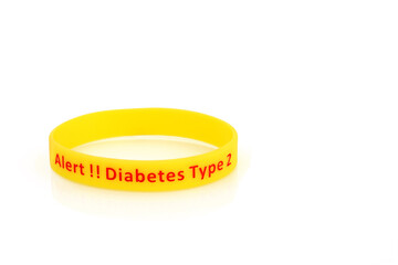 Diabetes type 2 alert wristband in yellow rubber silicone with red type on white background.