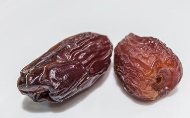 Two Fresh Dried Dates Fruit on White Background