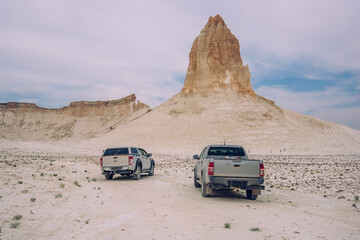 Automobiles on sandy road of desert