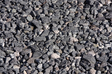 Close-up sectional full frame view of railway gravel on the ground along the tracks