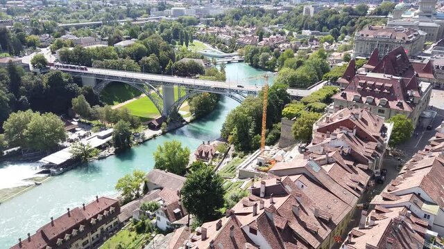 Aerial view of details of bridges in Bern old town, Switzerland, UNESCO World Heritage Site since 1983 from Cathedral bell tower. Skyline cityscape of medieval houses and roofs.