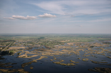 view from the window of a small plane on the city and fields, landscape