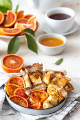 Traditional french crepes suzette with red bloody oranges