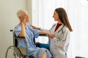 Obraz premium Caucasian old senior depressed upset woman patient on wheelchair talking to medical doctor with stethoscope in hospital 