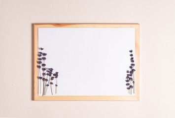 mock up for text, top view, white sheet of paper in a frame with lavender flowers