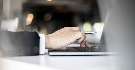 A business man using a laptop.