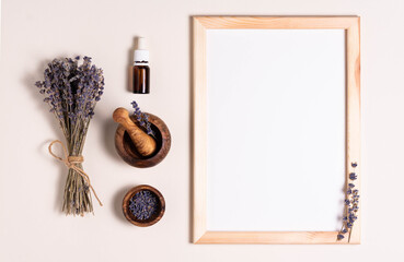 mock up for text, top view, white sheet of paper in a frame with lavender flowers, mortar and essential oil