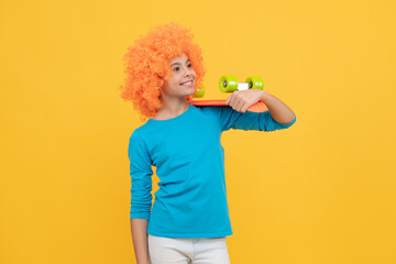 skateboarder. cheerful child holding penny board. teen girl with fancy hairstyle.