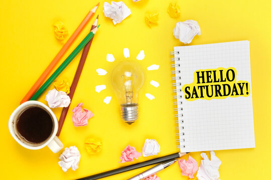 On a yellow background, a cup of coffee, a light bulb, pencils, a notebook with the inscription - HELLO SATURDAY