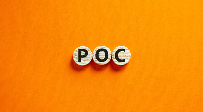 POC, proof of concept symbol. Wooden circles with the word POC, proof of concept. Beautiful orange background. Business and POC, proof of concept concept, copy space.