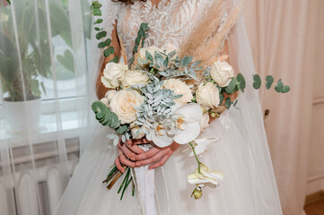 Bouquet of flowers in the hand of the bride