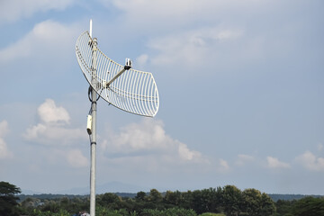 Outdoor internet wifi receiver and repeater installed on pole in long distant area of Thailand to receive signal from the wi-fi transmission tower and repeat it to the people's access points nearby.