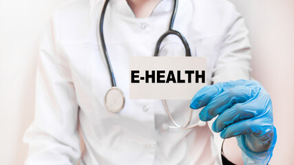 The doctor's blue - gloved hands show the word E-HEALTH - . a gloved hand on a white background. Medical concept. the medicine