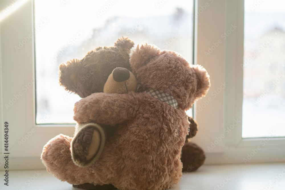 Wall mural couple of two teddy bears hug each other, love feelings concept