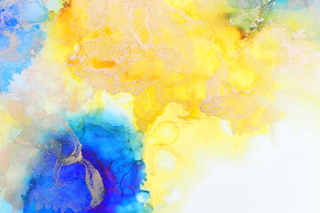 art photography of abstract fluid art painting with alcohol ink, blue, yellow and gold colors