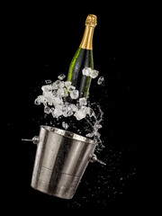 Champagne bottle with ice cubes up from a metal bucket