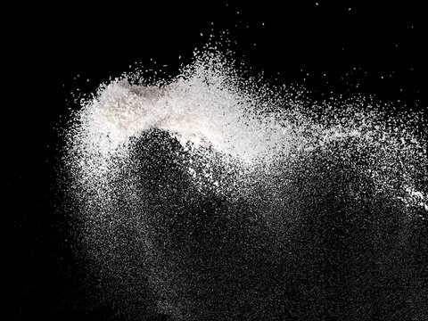 Fine crystal salt explosion on black background