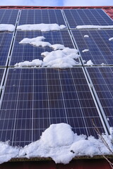solar panels partially covered with snow 