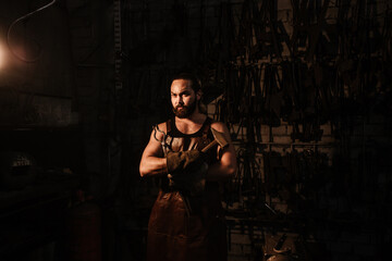 Fototapeta na wymiar Portrait of a blacksmith in a blacksmith shop