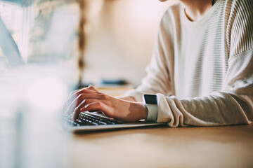 Person working on laptop sitting at table