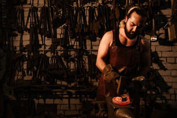 Fototapeta na wymiar Blacksmith shop with a blacksmith at work