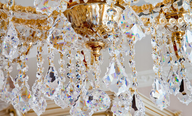 Big luxury golden chandelier with lot of crystals in macro