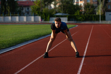 Fototapeta premium Athletic guy is ready to run outdoors