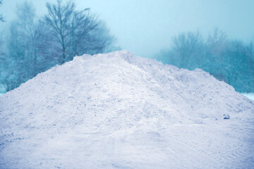 large pile of snow in the street near road, winter season