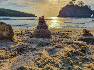 Little sand castles made by children in the cystal beach of Nusa Penida island of bali, Indonesia