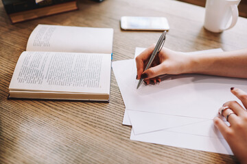 Woman writing notes on paper sheet