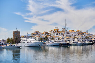 Fototapeta na wymiar View of Puerto Banus marina with boats and white houses in Marbella town at sunrise, Andalusia, Spain