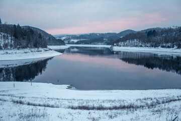 Winter landscape at Soesetalsperre in Harz Mountains National Park, Germany. Moody snow scenery in Germany
