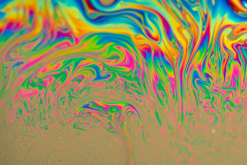 Abstract blurred multicolor background with a rainbow bright pattern. Liquid modern art. Soap bubbles, closeup.
