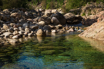 Fototapeta na wymiar Rock formation and reflection in Solenzara River, Corsica, France