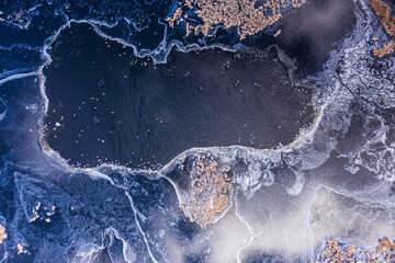 Aerial shot from a frozen lake with birds. 