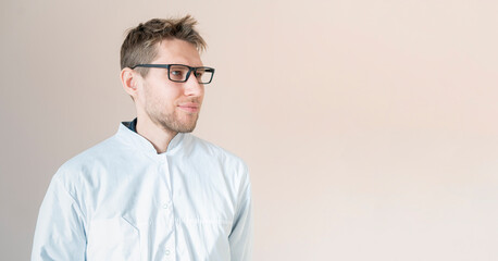 young male medical worker, doctor in white uniform, confident doctor