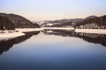Winter landscape at Soesetalsperre in Harz Mountains National Park, Germany. Moody snow scenery in Germany