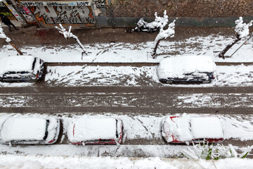 Cars totally covered with snow during snow storm in Eksarchia district, Athens city, the capital of...