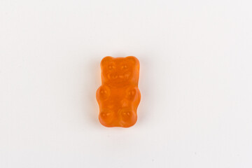 Children's vitamins in the form of bears are arranged in rows. A lot of multi-colored jelly sweets...