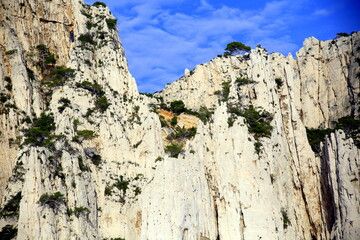 High part of the rocky cliff against blue sky, Parc National des Calanques, Marseille, France