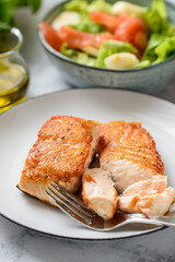 Pieces of salmon fried and served on a plate.