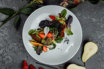 Salad with duck breast. Su-view duck fried in Teriyaki sauce, caramelized pear, tomatoes, salad mix, citrus sauce. copyright place