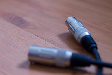 Xlr cable for sound microphone on wood background
black microphone cable, xlr cable on wooden background, music cable, guitar cable, voice cable,
