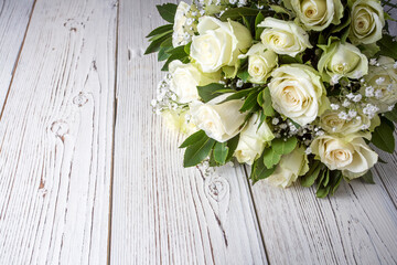 White roses on the wooden background.  Wedding bouquet concept.