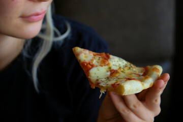 woman eating pizza close up