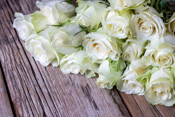 White roses on the wooden background.  Wedding bouquet concept.