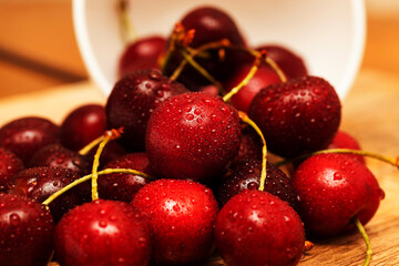 harvested sweet cherries in water droplets