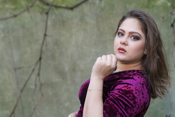 Portuguese woman with long straight hair and purple dress