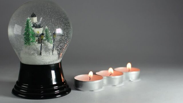 Cinemagraph snow globe with candles in a row