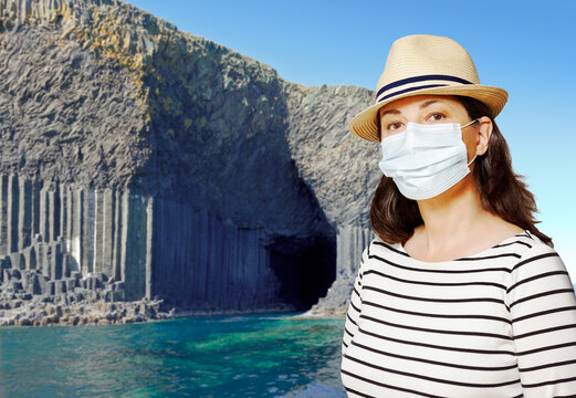 Travelling During The Corona Or Covid Pandemic: Woman Tourist Wearing Protective Face Mask At Staffa, Hebrides, Scotland.
